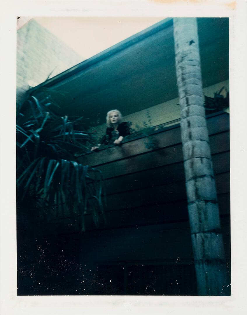 Unidentified Woman (Blonde Hair on Balcony)