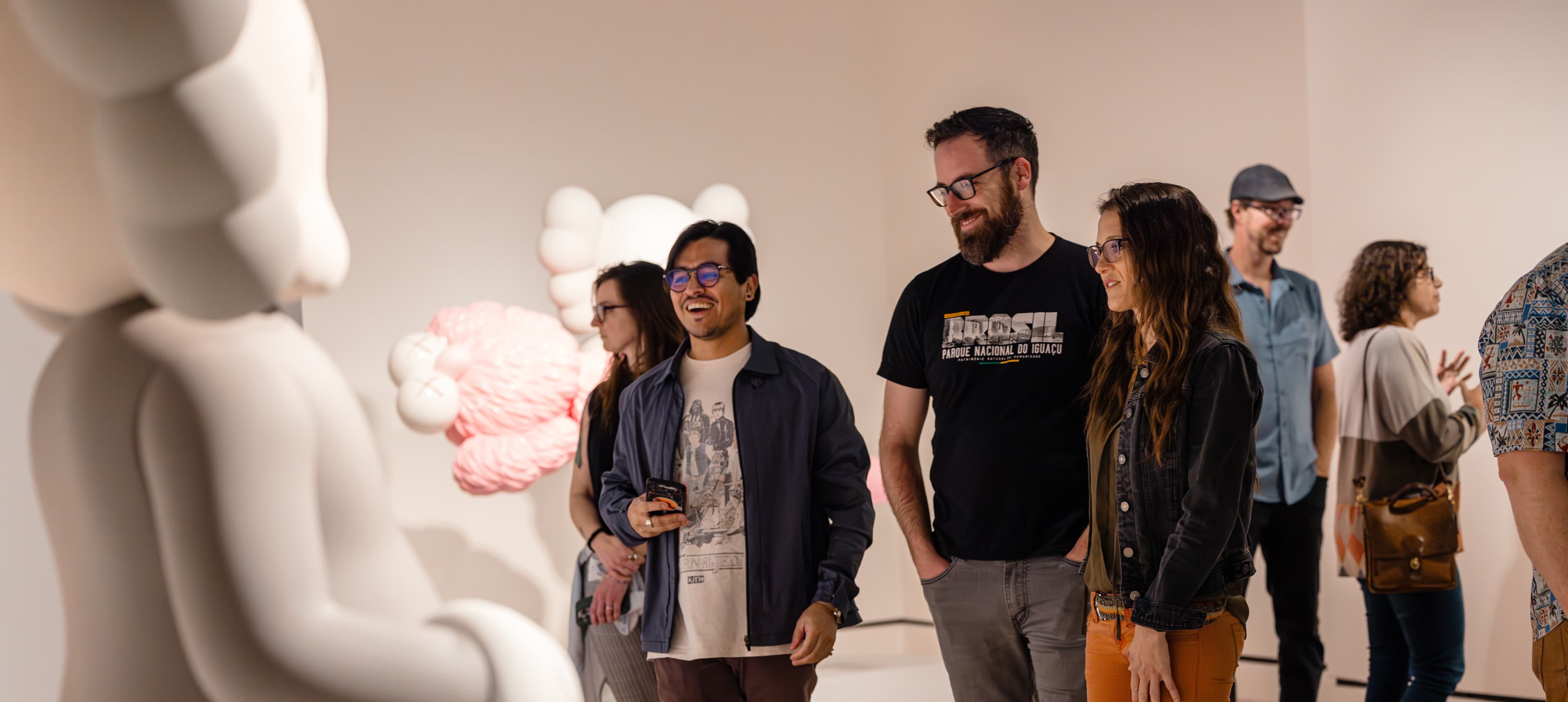 Members gather to see the exhibition KAWS: Family.